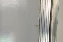 Protective film partially removed from clean whiteboard surface on modern platform.