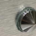 Corrosion in public toilet mirror support
